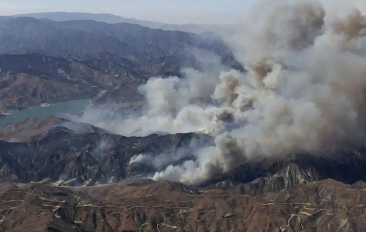 Smoke rises from mountains.