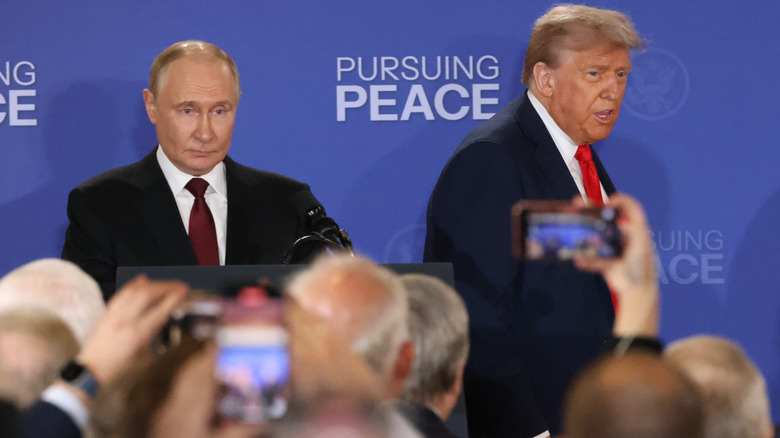 Crowd taking photos of Vladimir Putin and Donald Trump